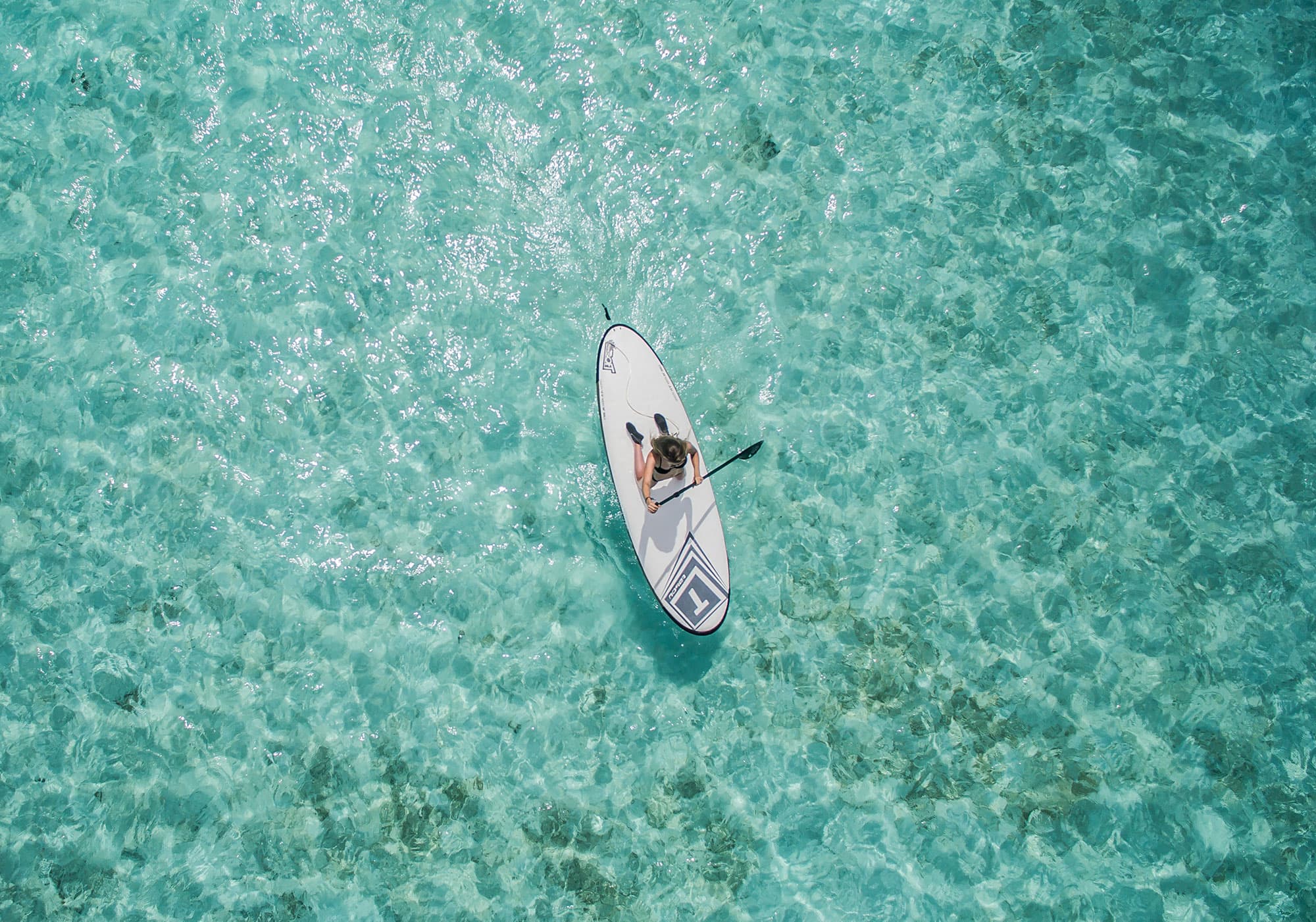 Paddleboarding on clear Bahamian water